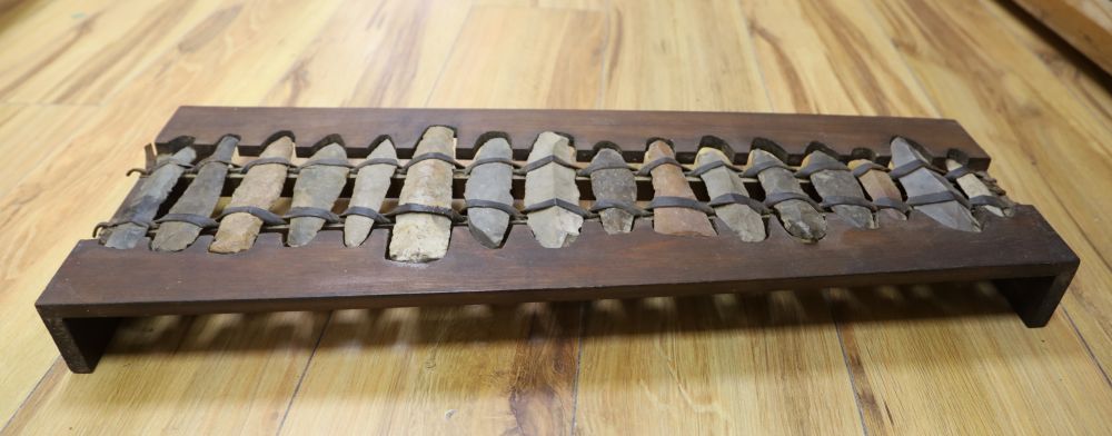 A xylophone formed from Stone Age flints, length 60cm